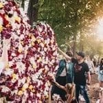 Several people adding flowers to a flower hall to hlep the victs of the Pulse nightclub shooting that happened June 12, 2016 in Orlando Florida