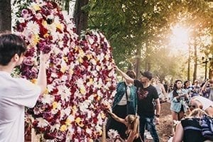 Several people adding flowers to a flower hall to hlep the victs of the Pulse nightclub shooting that happened June 12, 2016 in Orlando Florida