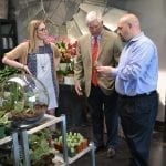 Three individuals standing in Dr. Delphinium Designs & Events in Dallas in March