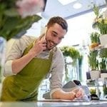 Man takes flower order on the phone