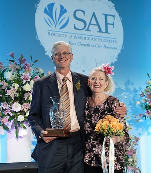 Bobbi Echter children collecting the Hall of Fame award on her behalf