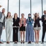 Group of diversity business people celebrating clapping hands for teamwork and successful