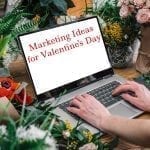 Florist using laptop with blank screen with flowers bouquet